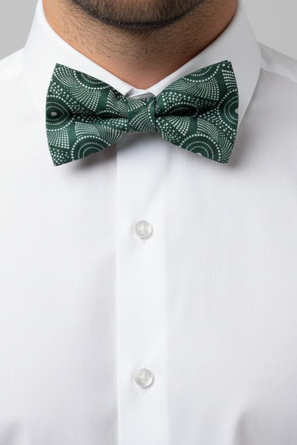 Green patterned shweshwe bow tie on a white background